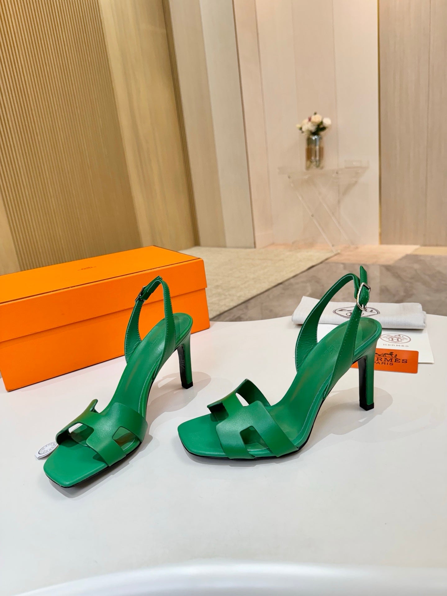 Pair of green strappy high-heel sandals with square-toe cutouts