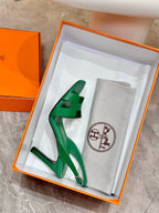 Green open-toe high-heel sandals in orange box with gray dust bag