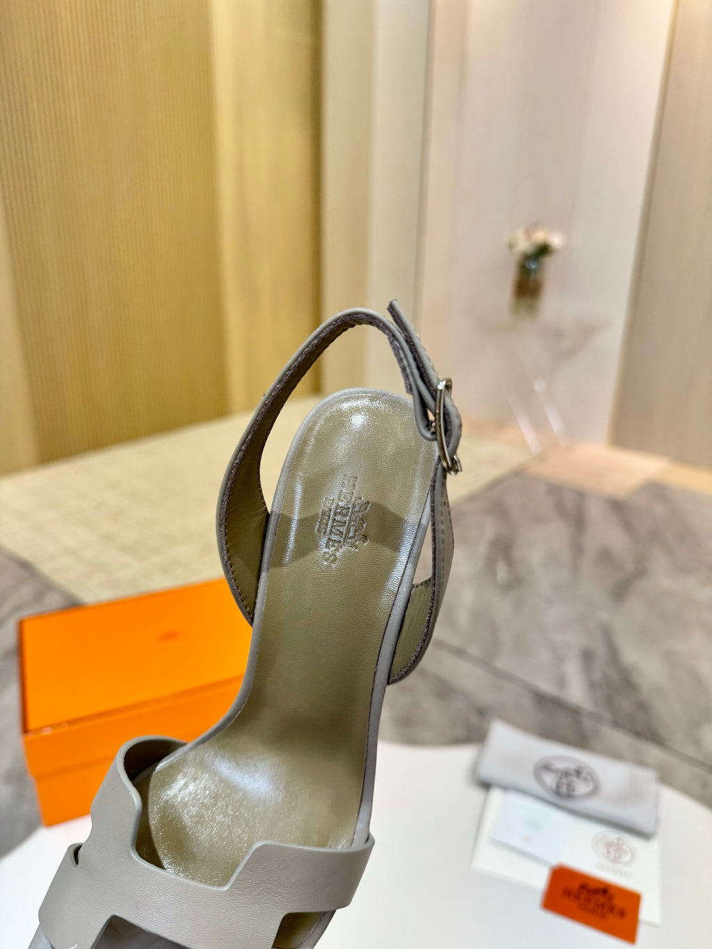 Hermes heeled sandal with light gray leather upper and slingback strap detail