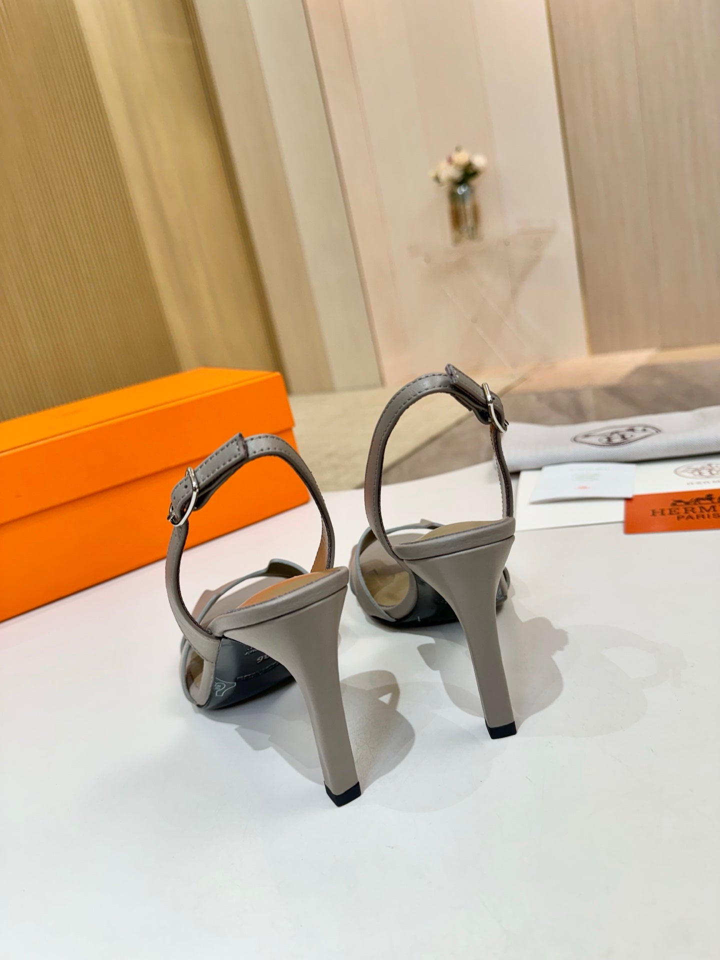 Hermes heeled sandals with light gray slingback straps and sculpted block heel