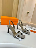 Hermes heeled sandals, light gray leather, cross strap over foot and sculpted block heel