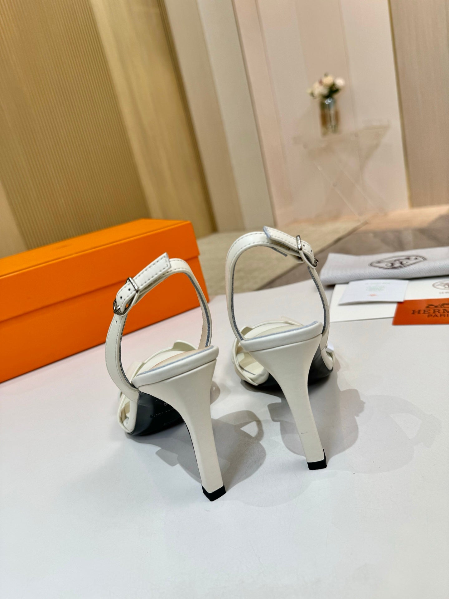 White leather heeled sandal with ankle strap and open toe, side view