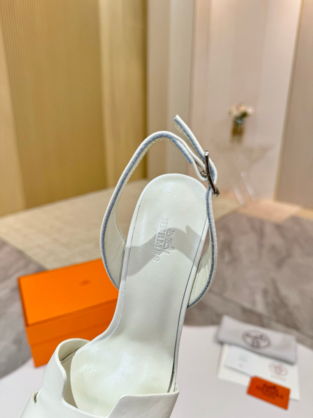 White leather heeled sandal with ankle strap, interior footbed visible