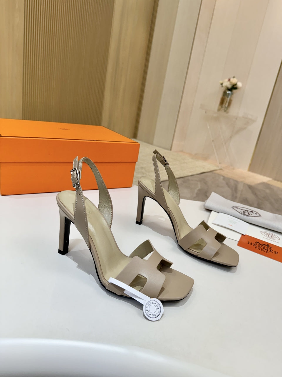 Hermes light beige heeled sandals with buckled ankle strap and black heel
