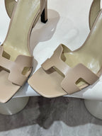 Hermes light beige heeled sandals close-up of front straps and black heel