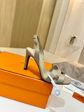 Hermes light beige heeled sandals with double straps and black stiletto heel
