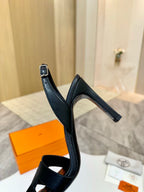Black heeled sandal with ankle strap and slingback-style back loop