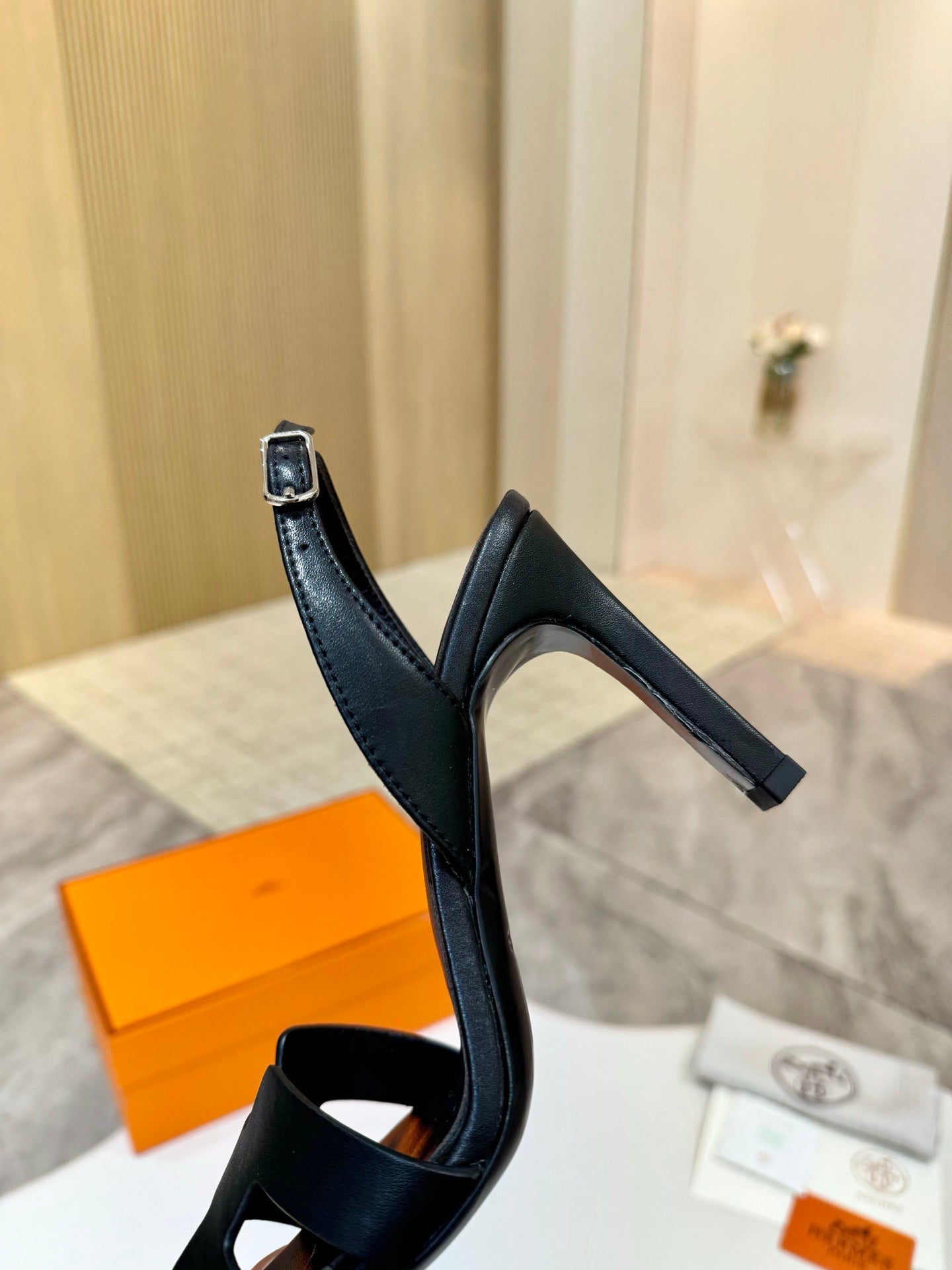 Black heeled sandal with ankle strap and slingback-style back loop
