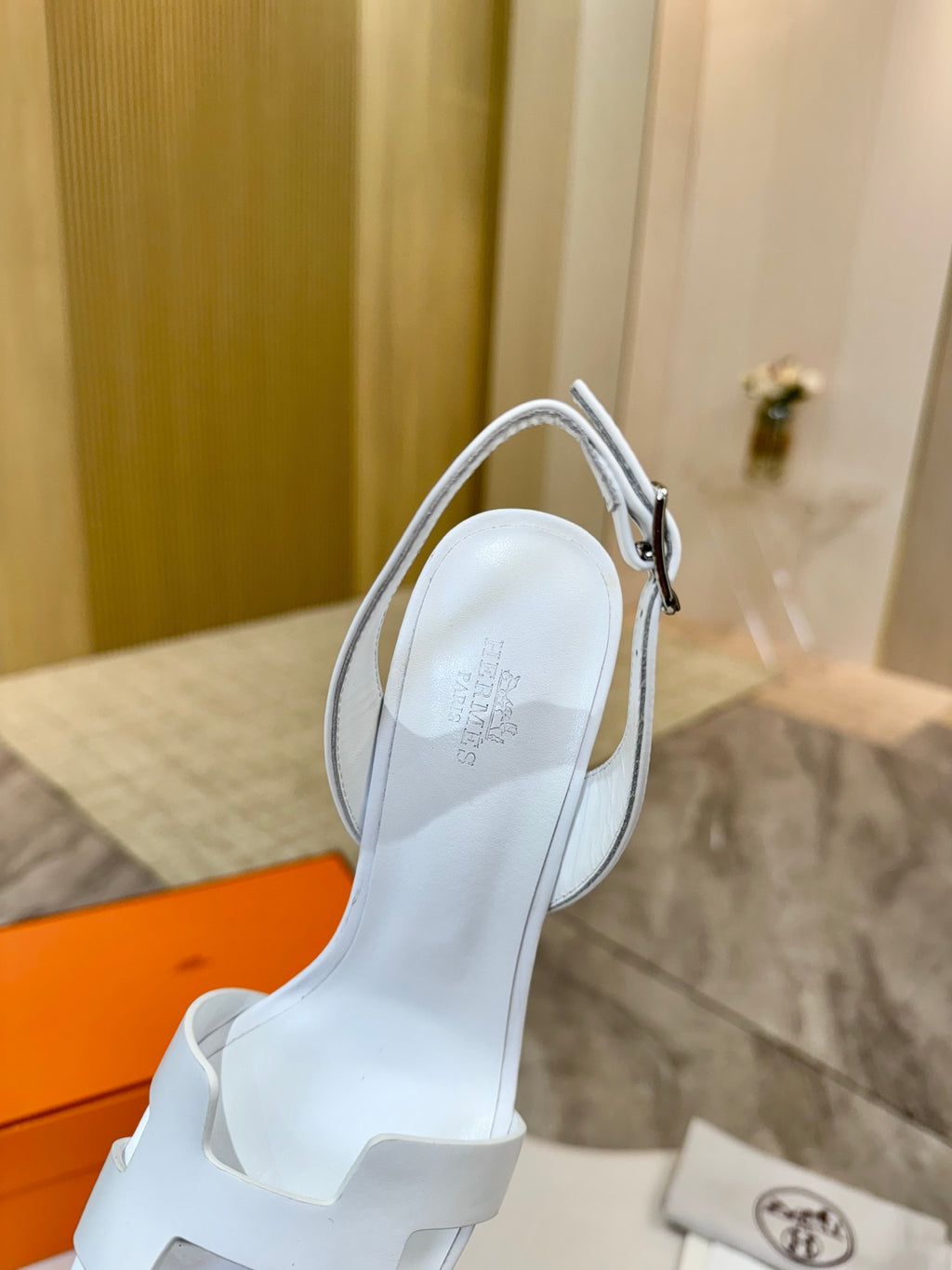 White slingback heeled sandal with ankle strap and cutout toe strap