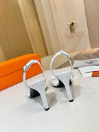 White heeled sandals with ankle straps and open toe, side view