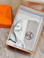 White heeled sandal and matching dust bag in orange-trimmed box