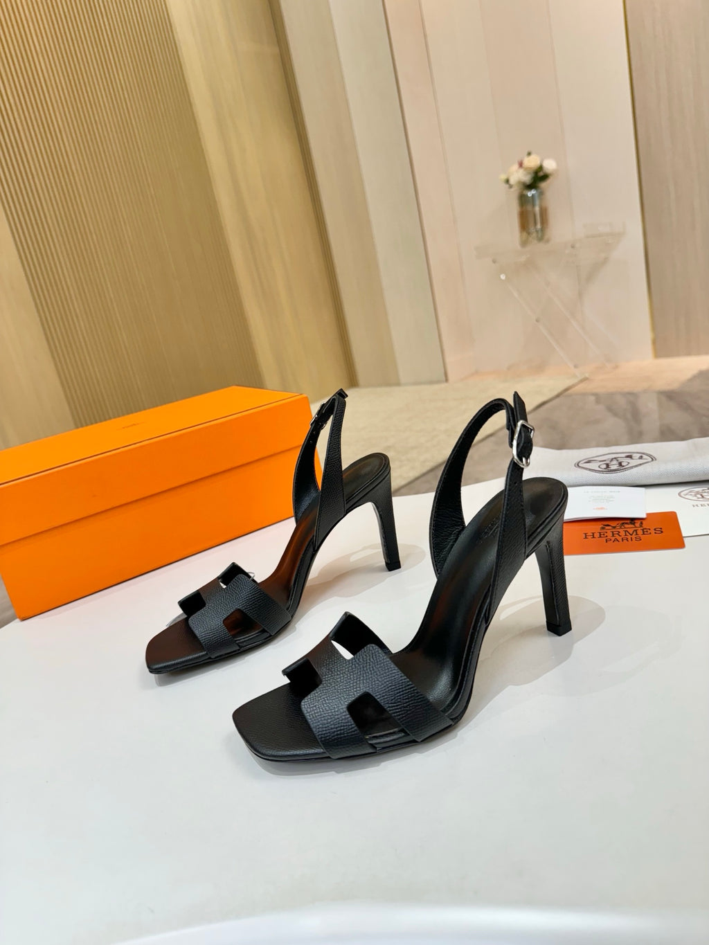 Hermes black heeled slingback sandals with wide cutout straps and sculpted heel
