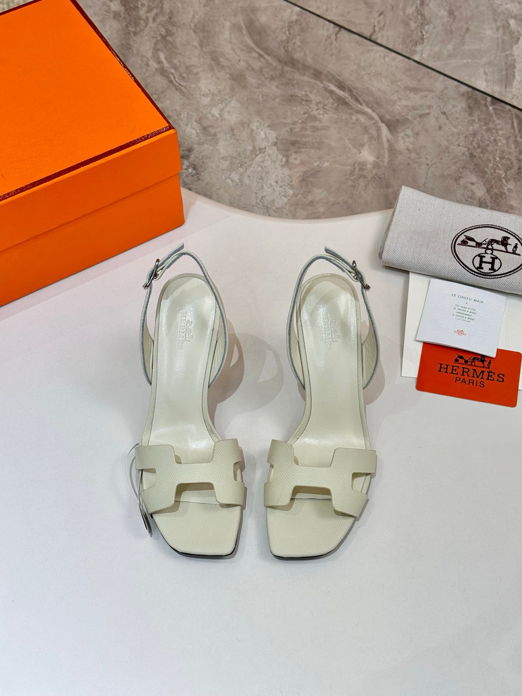 Hermes ladies heeled sandals in light cream leather with ankle straps, pair view