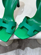 Hermes ladies green heeled sandals close-up of textured straps and buckle