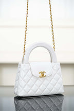 Chanel quilted handbag with gold chain strap and front logo clasp