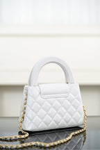 Chanel quilted handbag with top handle and gold chain strap, side view
