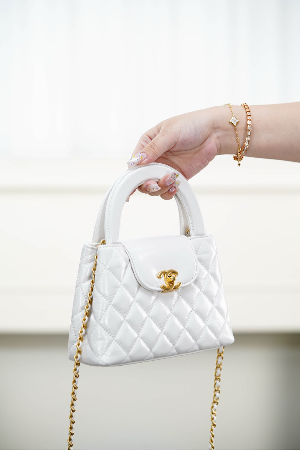 Chanel quilted handbag with top handle, gold chain strap and logo front