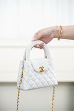 Chanel quilted handbag with top handle, gold chain strap and logo front