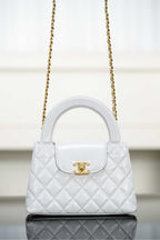 Chanel quilted handbag with top handle, gold chain strap and flap closure