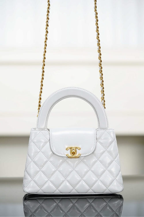 Chanel quilted handbag with top handle, gold chain strap and flap closure