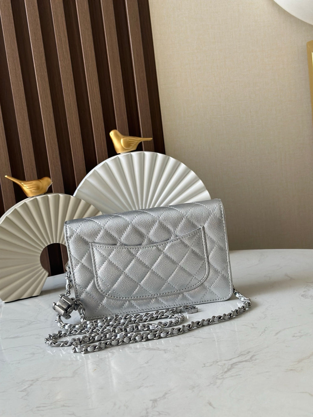 Silver quilted Chanel flap shoulder bag with chain strap and CC turn-lock clasp
