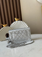 Silver quilted Chanel flap shoulder bag with chain strap and CC turn-lock clasp