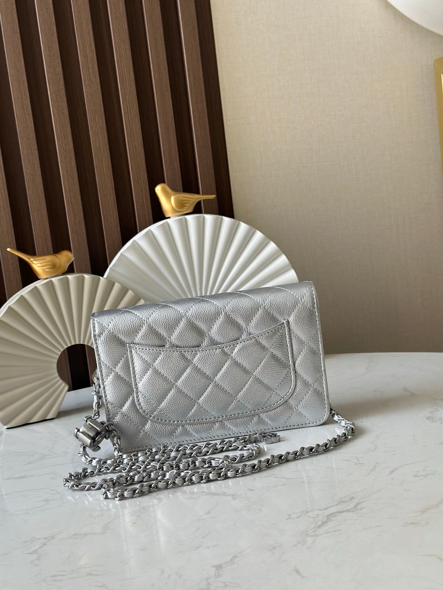 Silver quilted Chanel flap shoulder bag with chain strap and CC turn-lock clasp