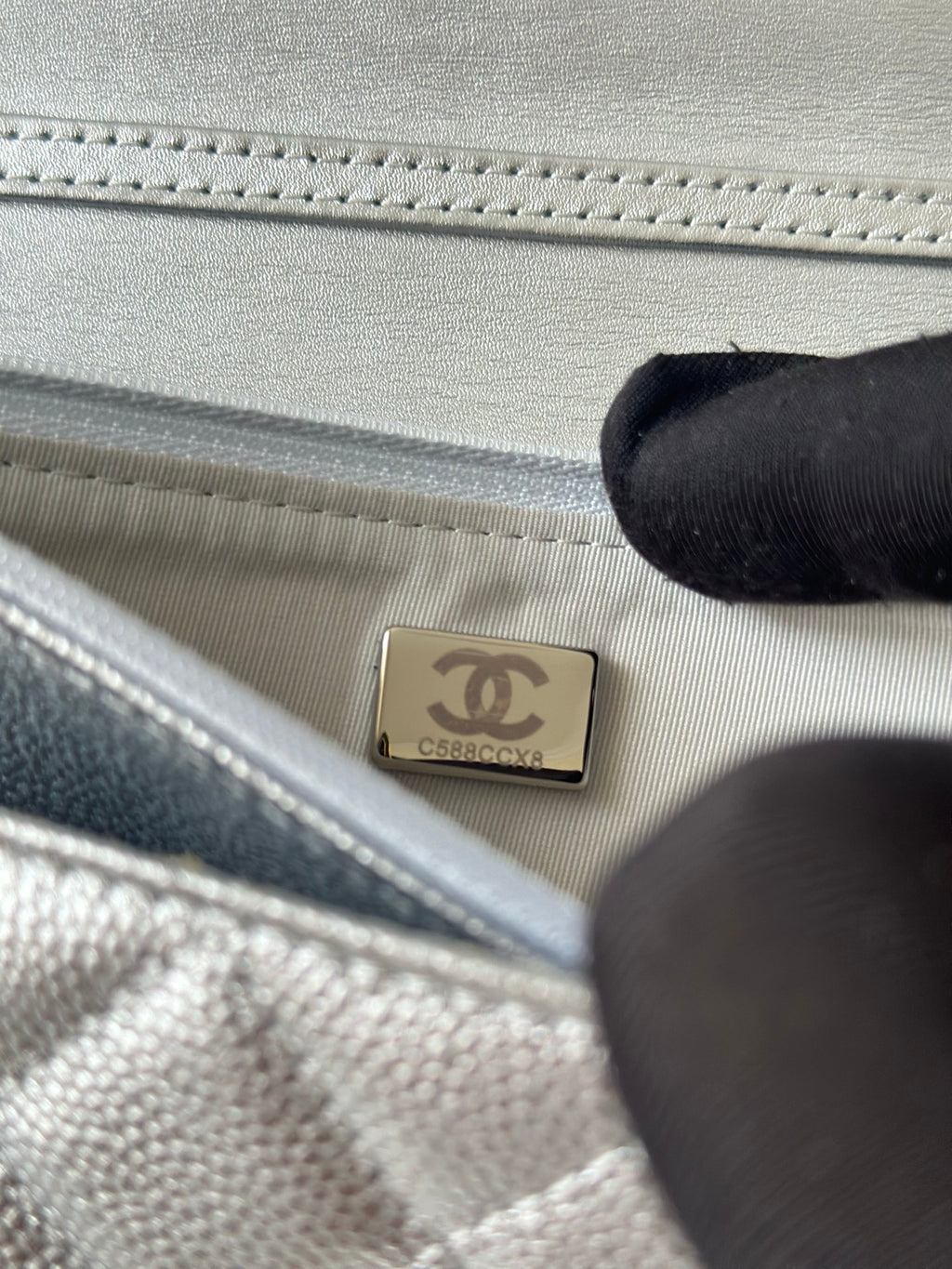 Silver Chanel interior label patch in quilted bag lining