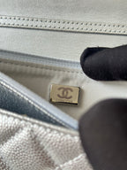 Silver Chanel interior label patch in quilted bag lining