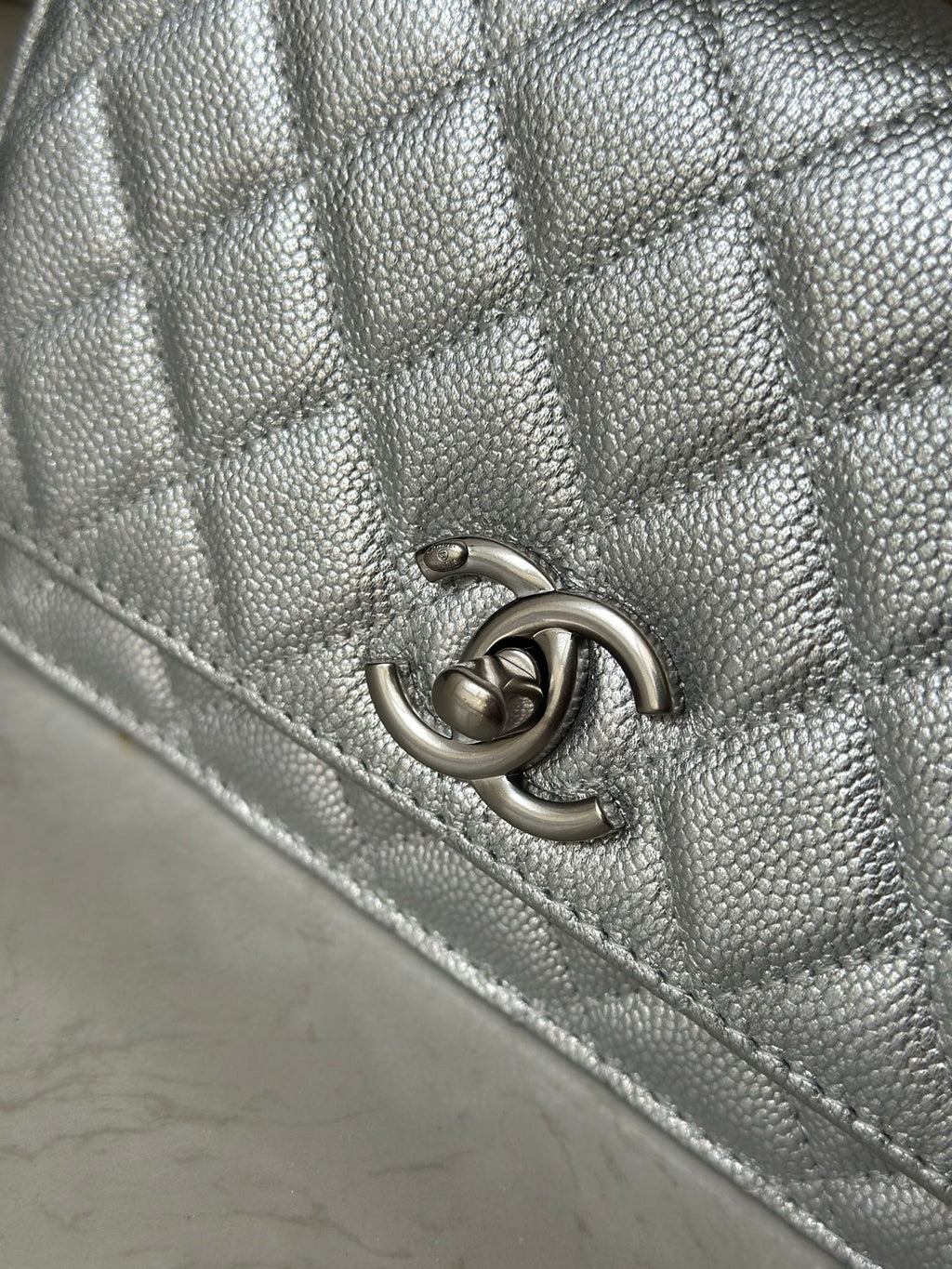 Silver Chanel CC logo clasp on quilted bag flap