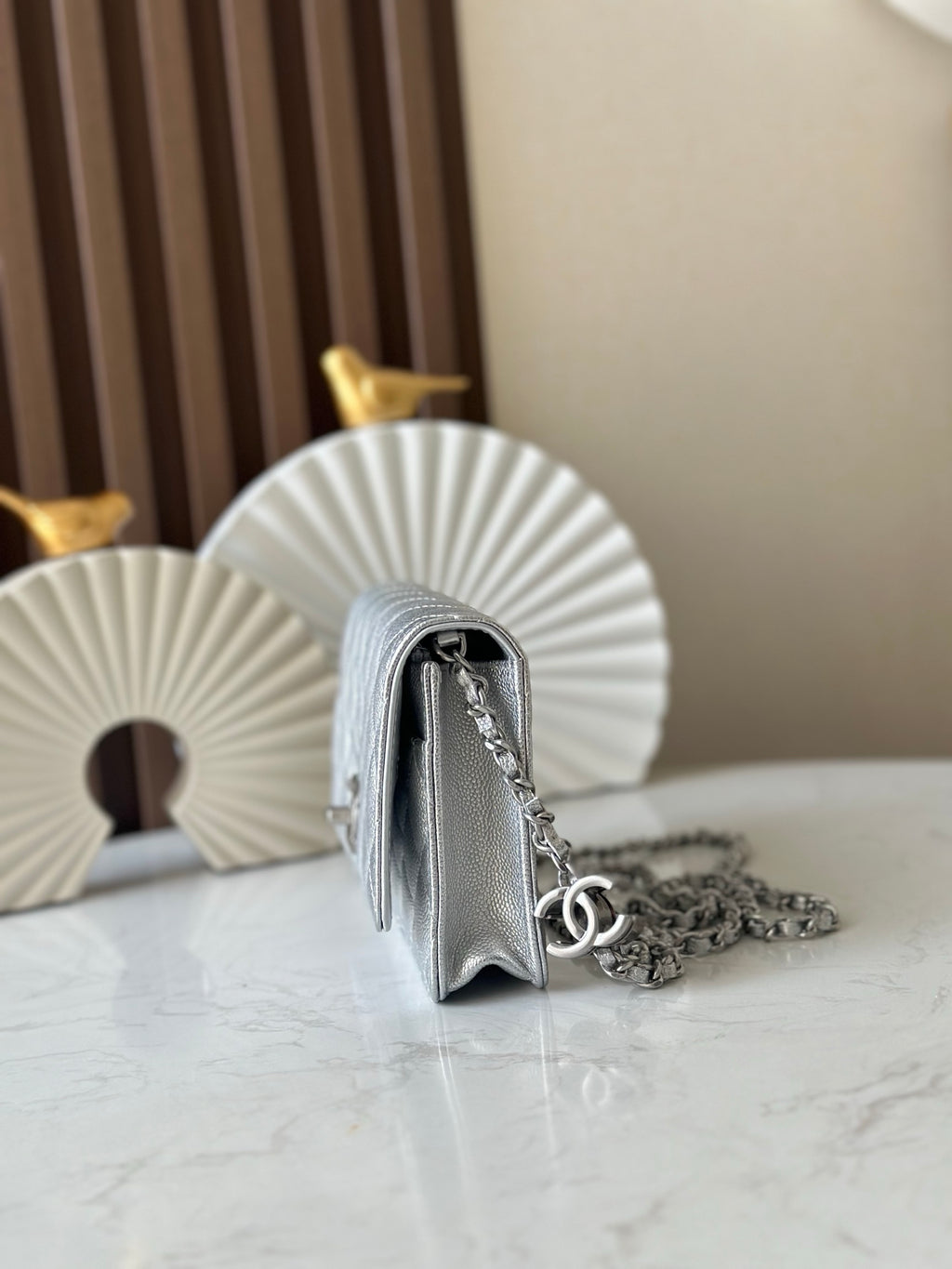 Silver Chanel mini bag with quilted sides and chain strap, front flap partially visible