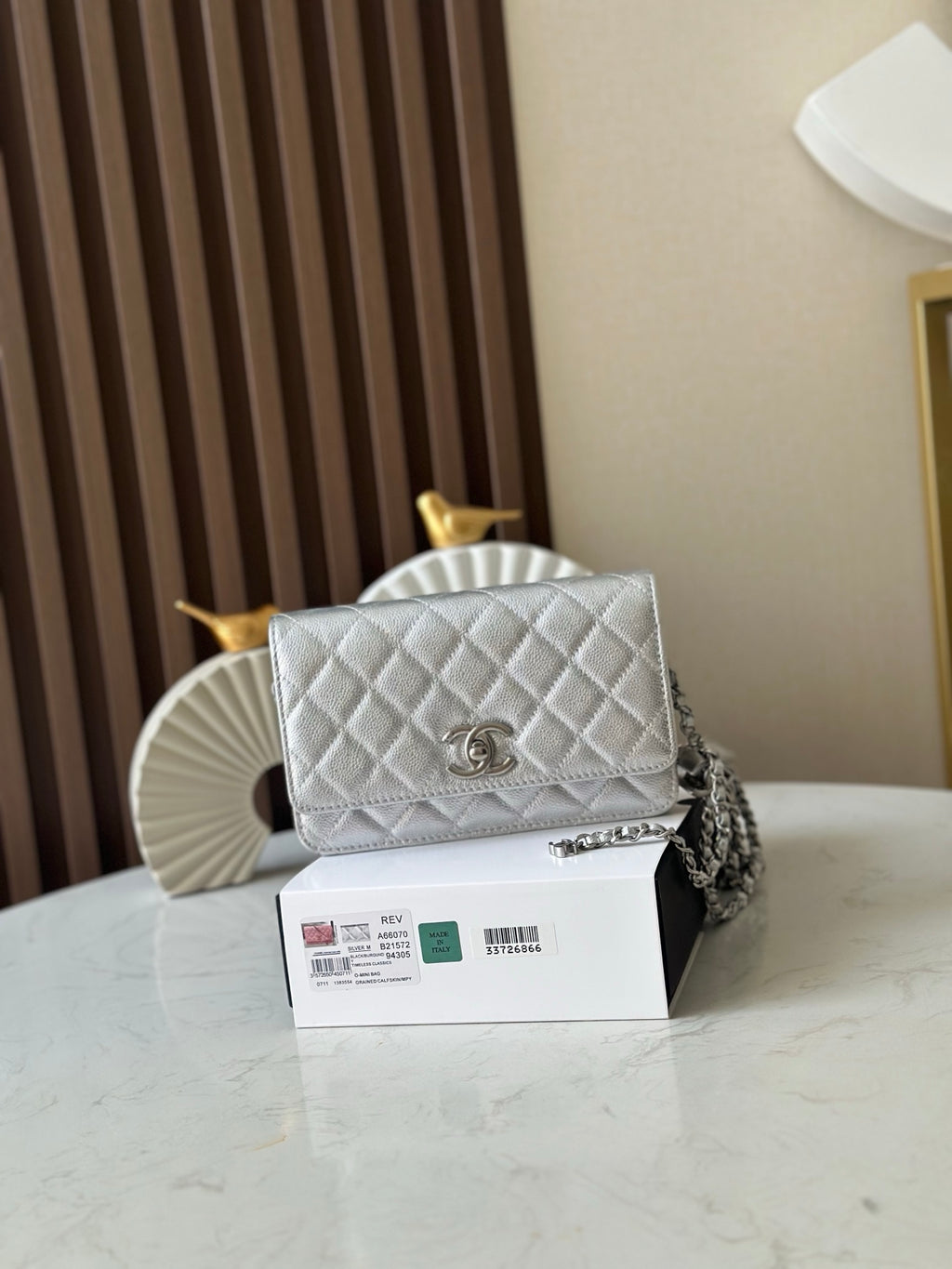 Silver quilted Chanel flap shoulder bag with chain strap and CC turn-lock clasp
