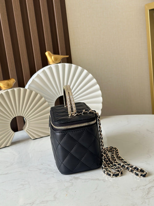 Quilted black mini crossbody bag with gold chain strap and zipper closure