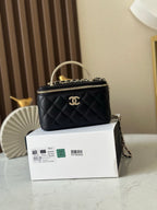 Quilted black mini bag with top handle, gold chain strap, CC logo front