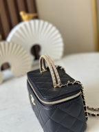 Quilted black mini bag with gold chain strap and glittery top handle