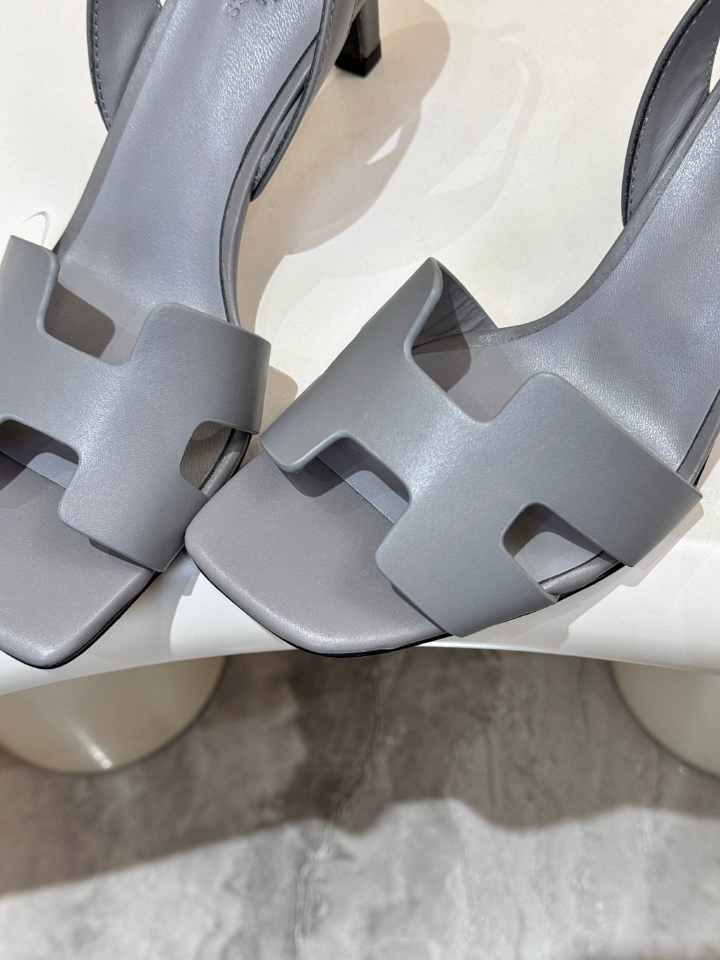 Light blue heeled sandal close-up: square-cut strap detailing and block heel