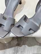 Light blue heeled sandal close-up: square-cut strap detailing and block heel