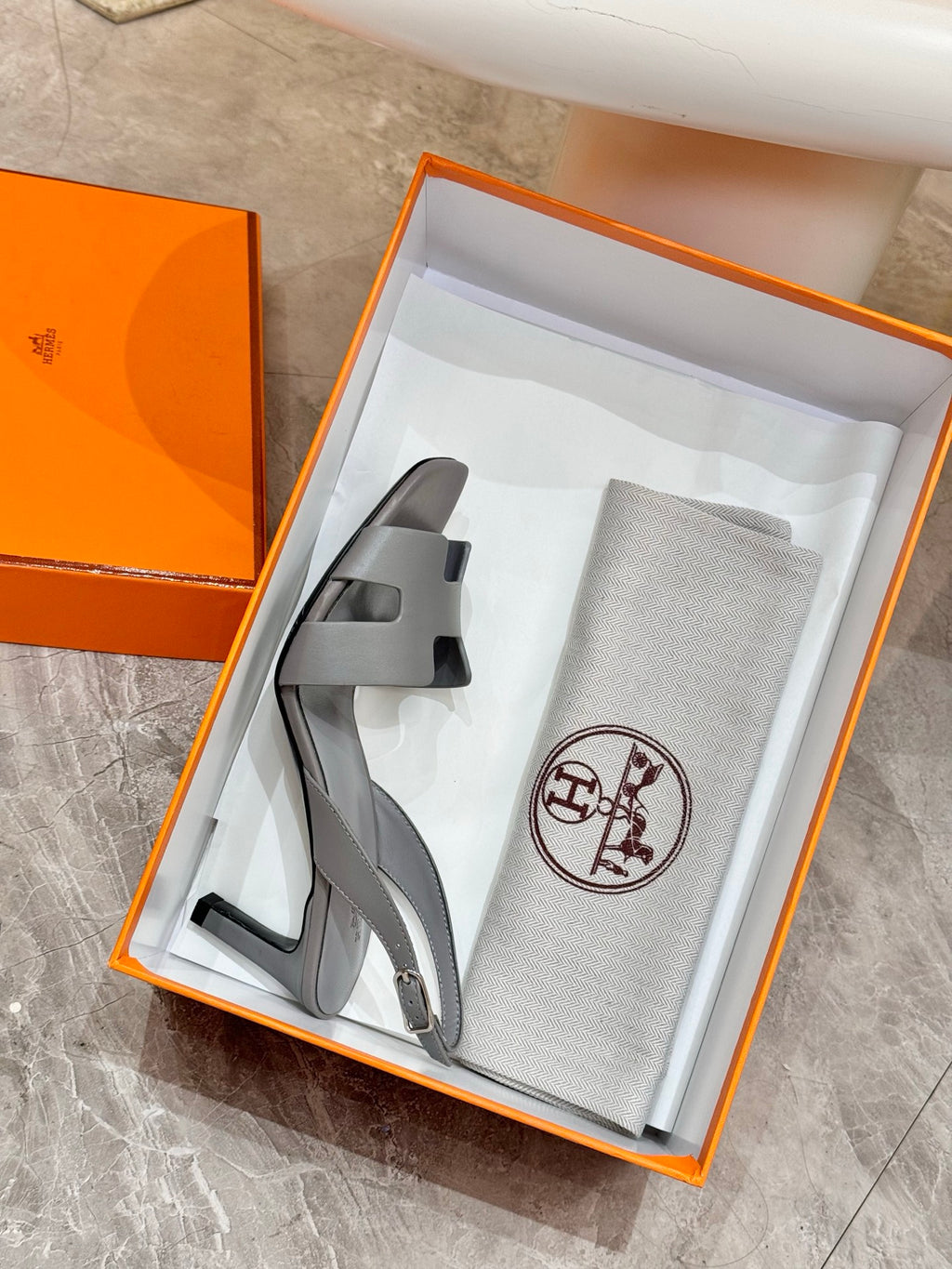 Light blue heeled sandals in orange gift box with dust bag