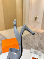 Light blue heeled sandal side view with thin ankle strap and buckle detail