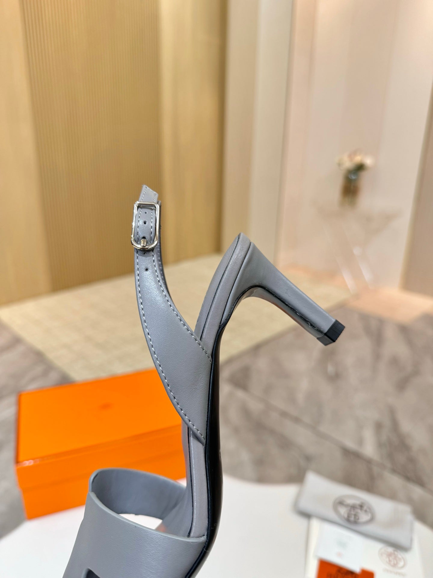 Light blue heeled sandal side view with thin ankle strap and buckle detail