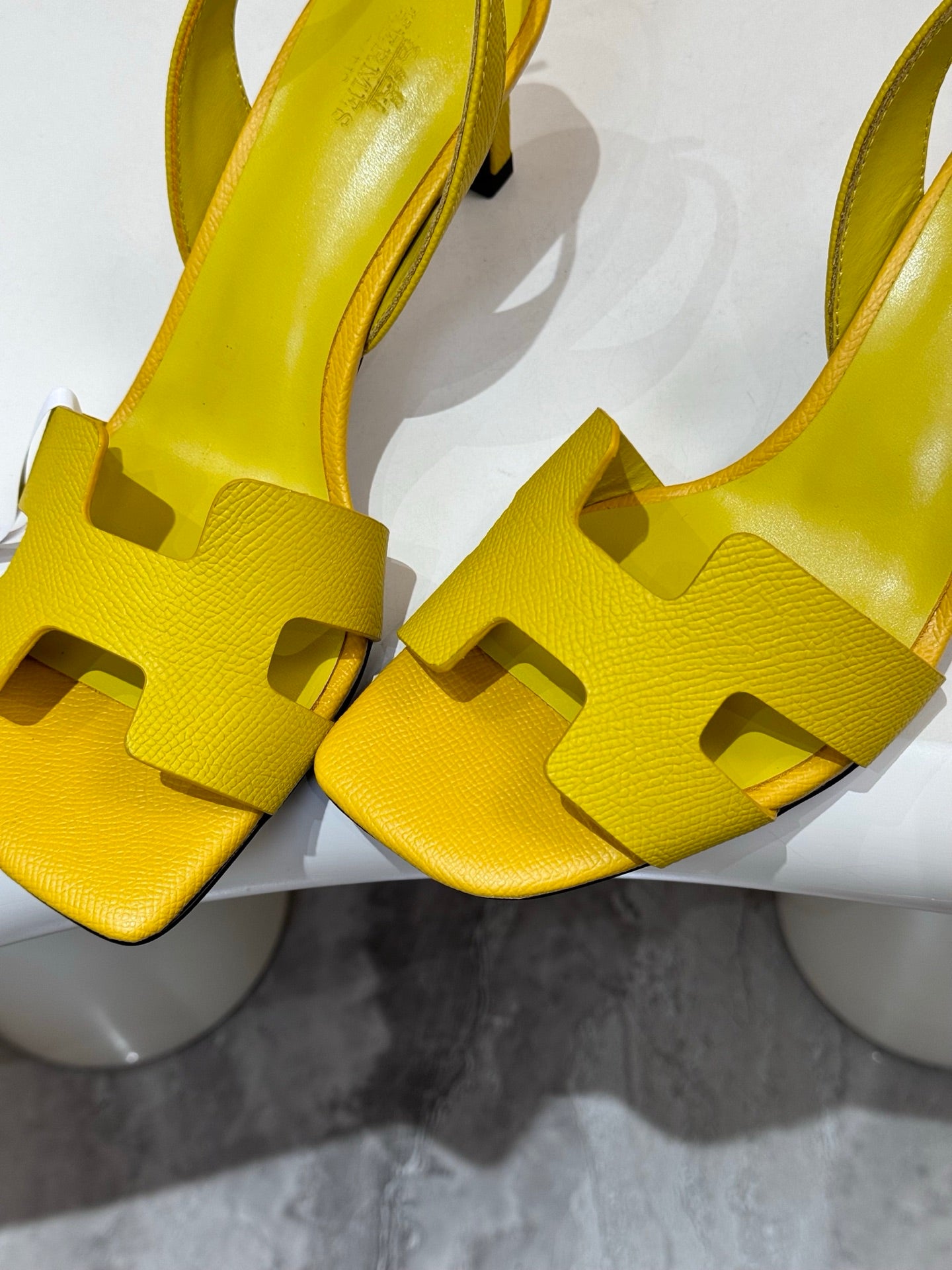 Hermes yellow leather slingback sandals close-up of cutout vamp and block heel