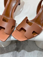 Hermes women's tan leather heeled sandal close-up, T-strap and cutout detailing