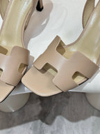 Hermes ladies heeled sandal close-up in light beige with cutout strap design
