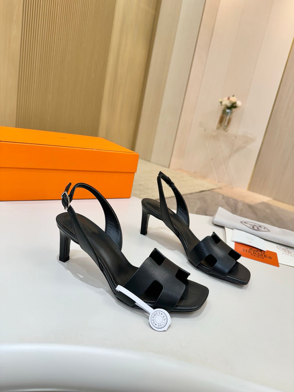 Black heeled sandals with slingback ankle strap and block heel, leather-look upper