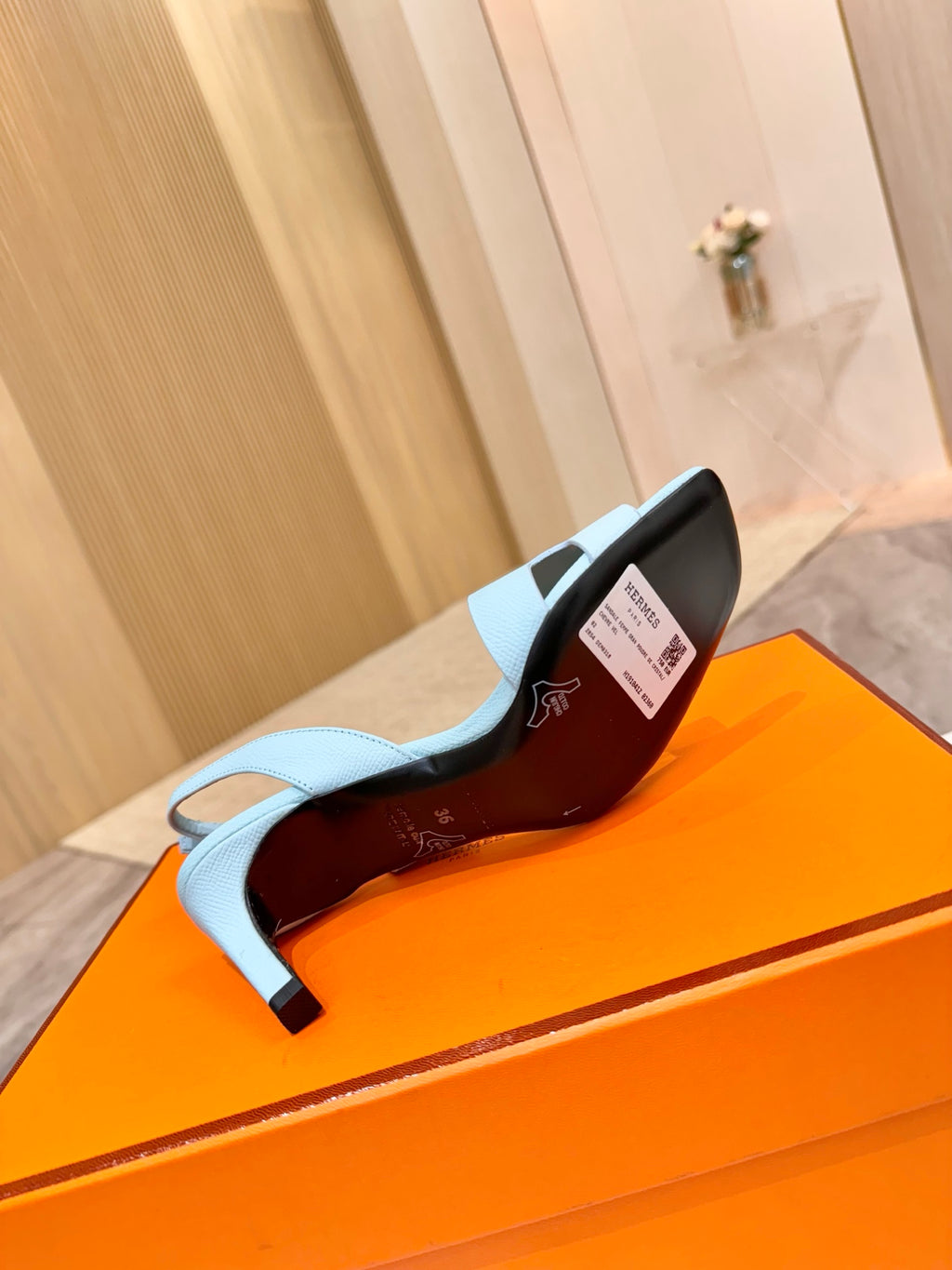 Hermes light blue heeled sandal showing red-lined interior and covered heel