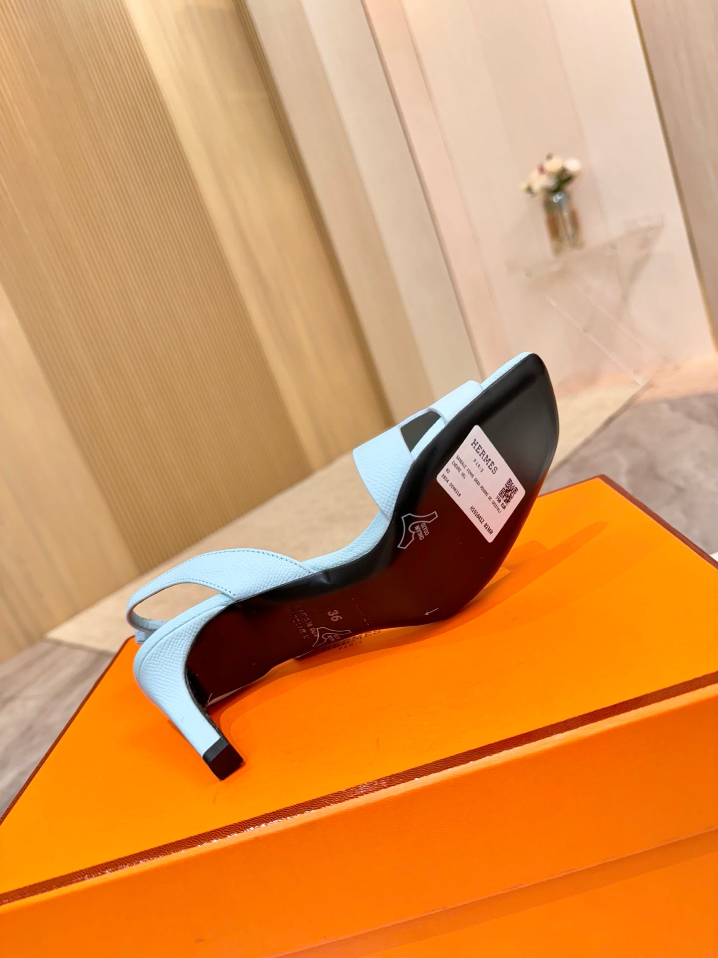 Hermes light blue heeled sandal showing red-lined interior and covered heel