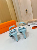 Hermes light blue heeled sandals with open toe and ankle strap, side angle