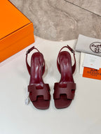 Burgundy leather heeled sandals with wide T-strap and slingback, open toe.
