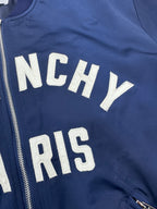 Dark blue bomber jacket zip front with partial "NCHY" and "PARIS" lettering