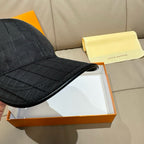 Black baseball cap side and brim with quilted grid pattern, close-up view